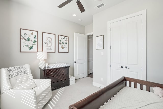 bedroom featuring ceiling fan, light colored carpet, and a closet