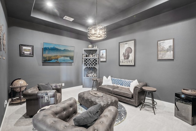 carpeted living room with a raised ceiling