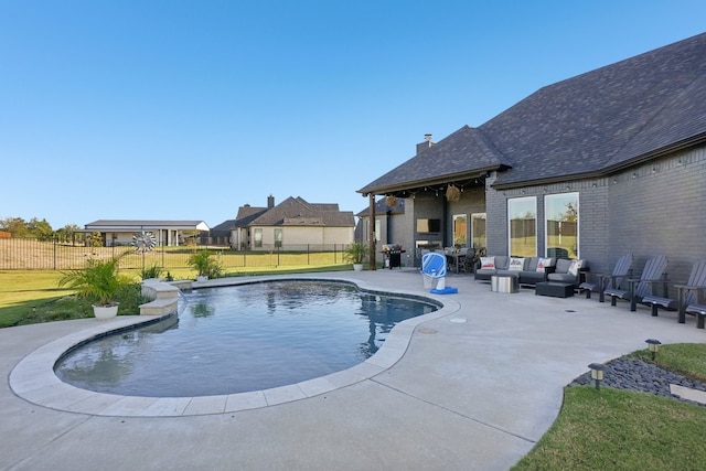 view of pool featuring a yard, an outdoor hangout area, and a patio area