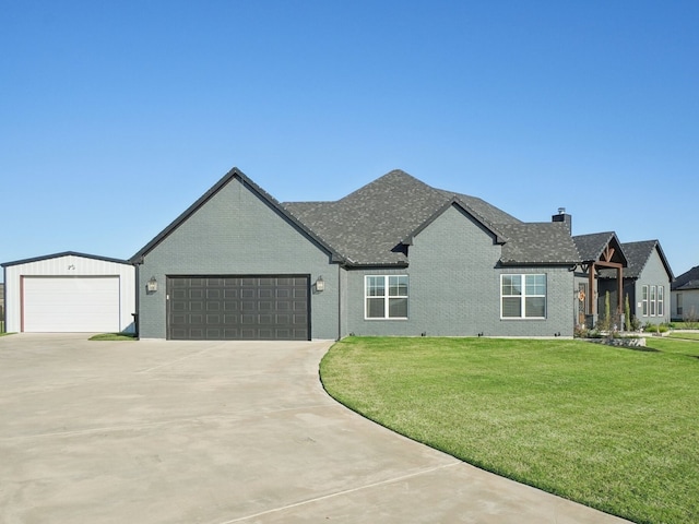 view of front of house featuring a garage and a front lawn