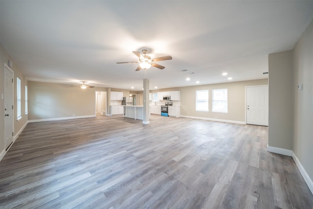 unfurnished living room featuring light hardwood / wood-style floors and ceiling fan