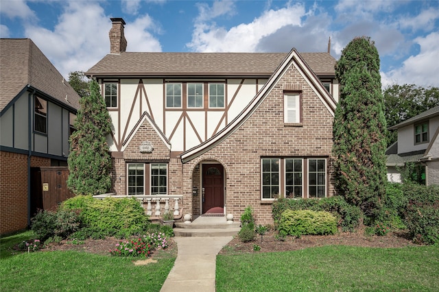 tudor house featuring a front lawn