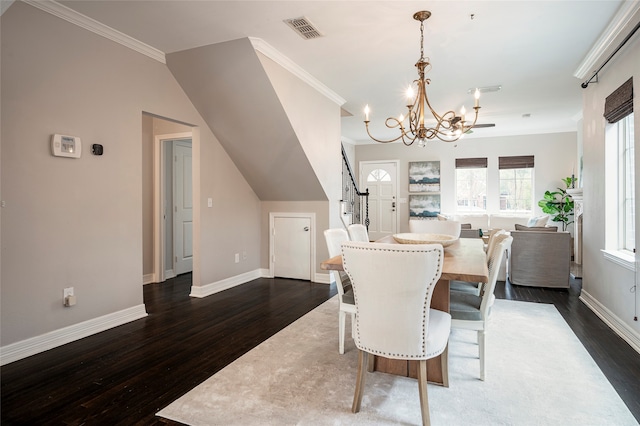 dining area with ornamental molding, a chandelier, vaulted ceiling, and dark hardwood / wood-style flooring