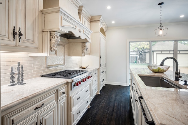 kitchen with a wealth of natural light, sink, pendant lighting, and dark hardwood / wood-style floors