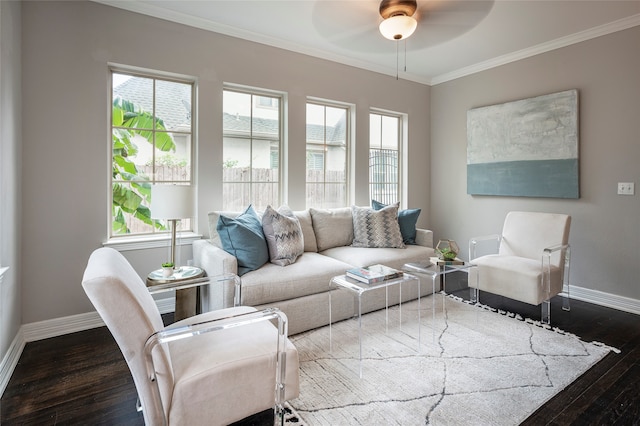 living room with ornamental molding, dark hardwood / wood-style floors, and ceiling fan