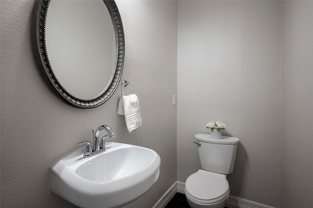 bathroom featuring toilet and sink