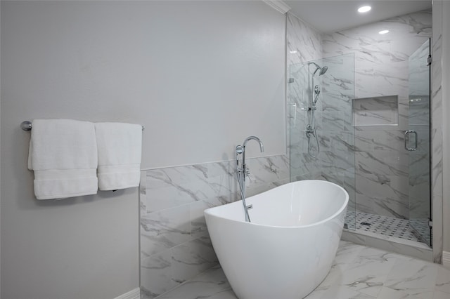 bathroom featuring tile walls and plus walk in shower