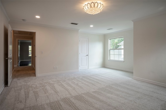 carpeted spare room featuring ornamental molding