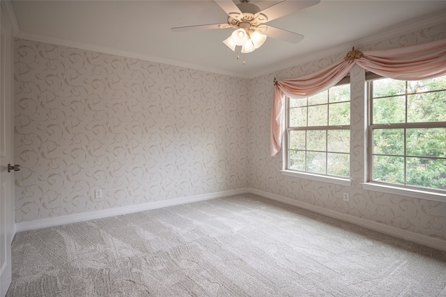 empty room with crown molding, carpet flooring, and ceiling fan