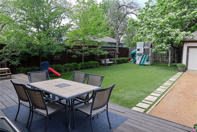 deck with a playground and a yard