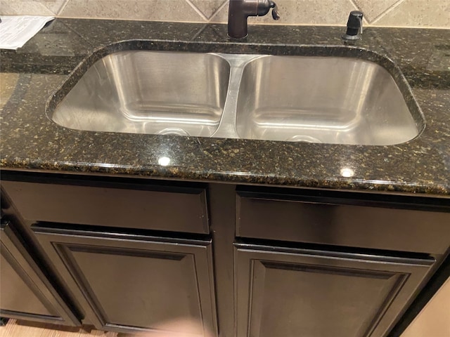 interior details featuring sink and dark stone counters