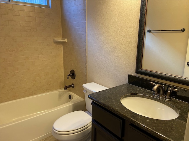 full bathroom featuring toilet, tiled shower / bath combo, and vanity