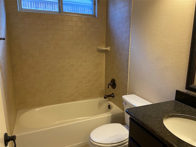 full bathroom with toilet, tiled shower / bath, and vanity