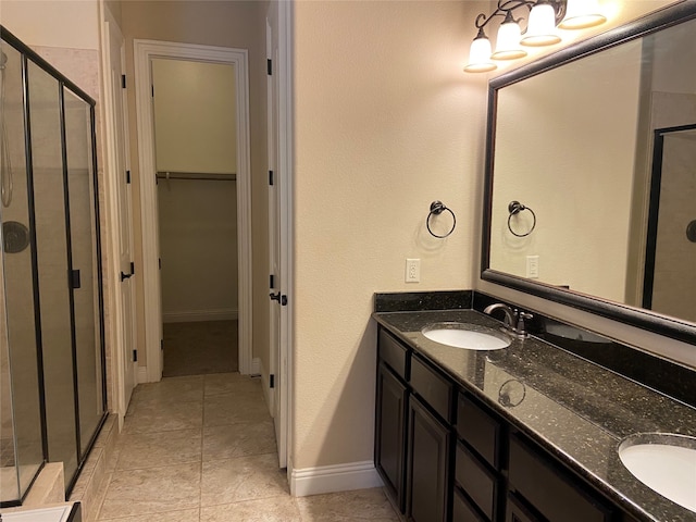 bathroom featuring vanity, tile patterned floors, and a shower with door