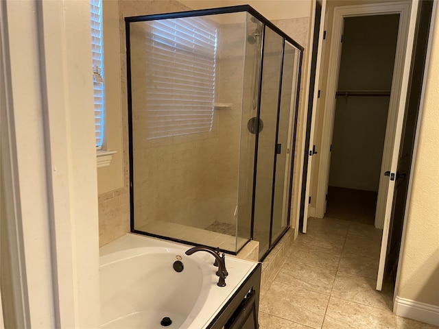 bathroom featuring tile patterned flooring, shower with separate bathtub, and vanity