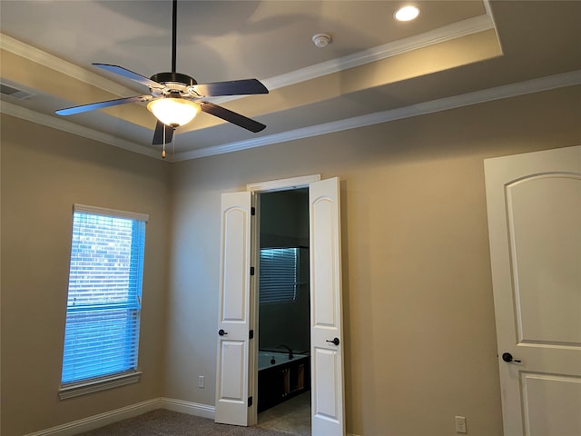 unfurnished bedroom with ornamental molding, ensuite bath, and ceiling fan