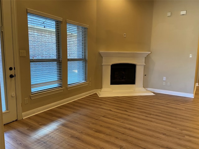 unfurnished living room with wood-type flooring