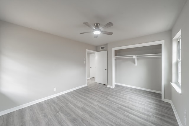 unfurnished bedroom featuring ceiling fan, a closet, and light hardwood / wood-style floors