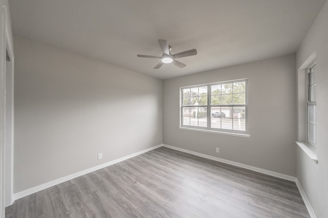 unfurnished room with light wood-type flooring and ceiling fan