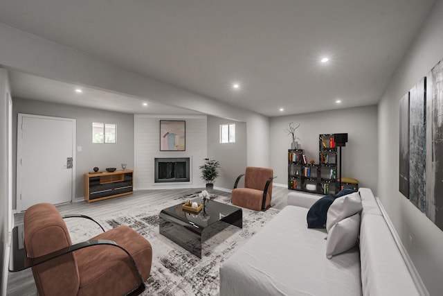 living room with light wood-type flooring and a fireplace