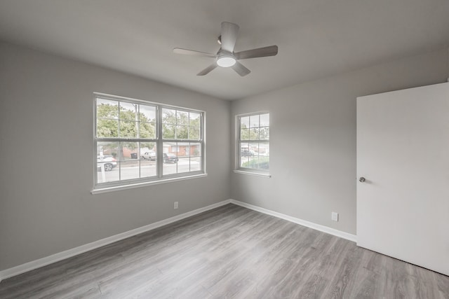 unfurnished room with ceiling fan and light hardwood / wood-style floors