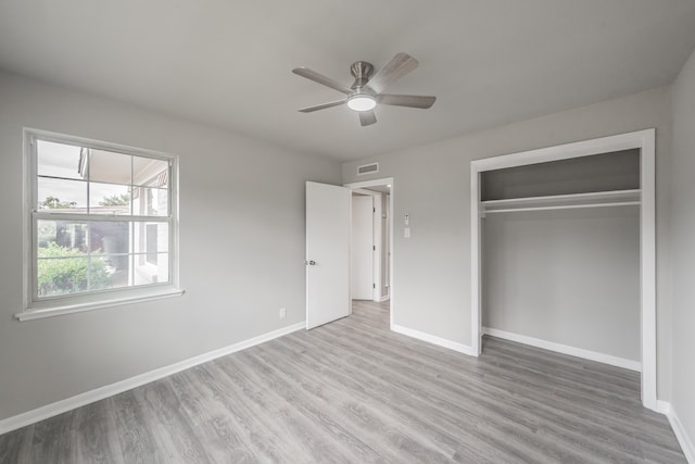 unfurnished bedroom featuring ceiling fan, a closet, and light hardwood / wood-style floors