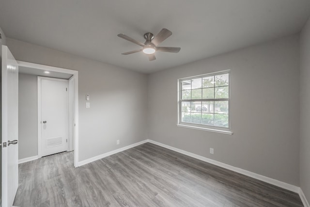 spare room with ceiling fan and hardwood / wood-style floors