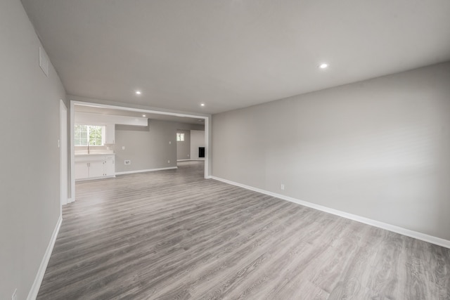 unfurnished living room with light hardwood / wood-style floors and a fireplace