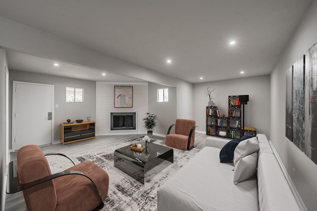 living room with a fireplace and light hardwood / wood-style flooring