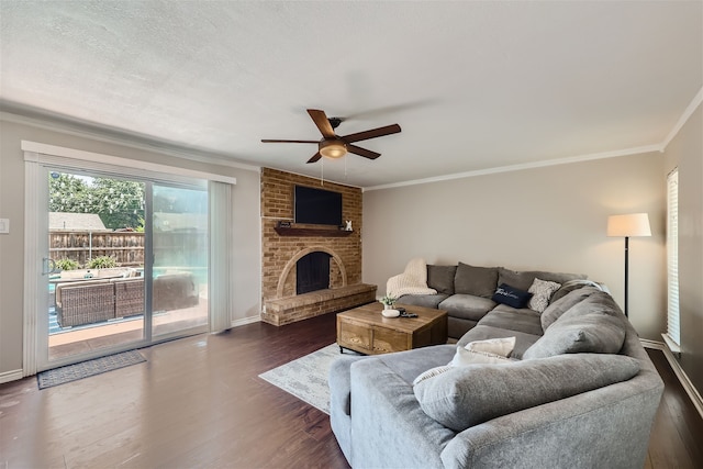 living room with ceiling fan, dark hardwood / wood-style floors, crown molding, and a fireplace