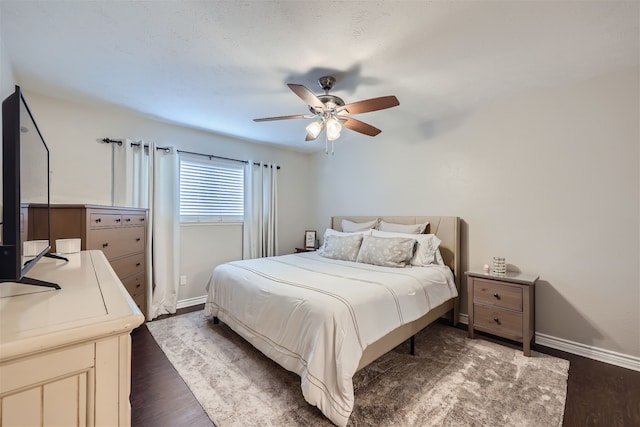 bedroom featuring ceiling fan and dark hardwood / wood-style flooring