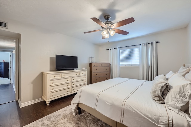 bedroom with ceiling fan and dark hardwood / wood-style flooring