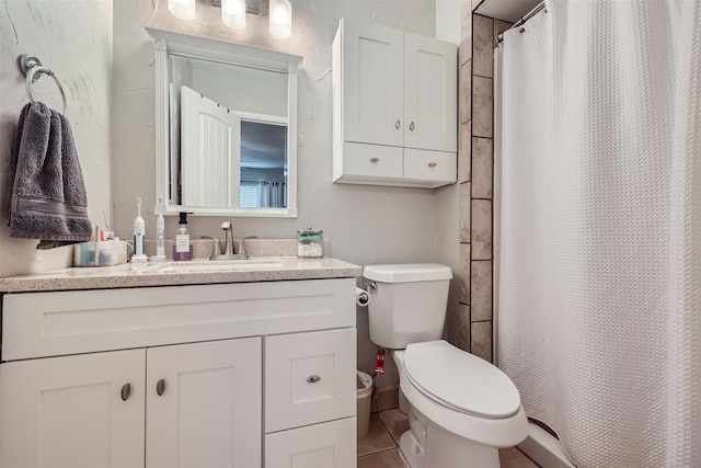 bathroom with toilet, walk in shower, tile patterned floors, and vanity