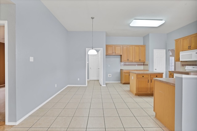 kitchen with white appliances, light tile patterned flooring, decorative light fixtures, and light brown cabinets