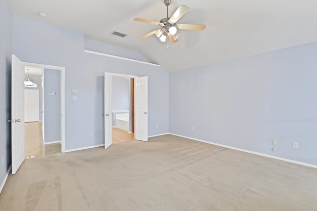 unfurnished bedroom featuring vaulted ceiling, light colored carpet, and ceiling fan