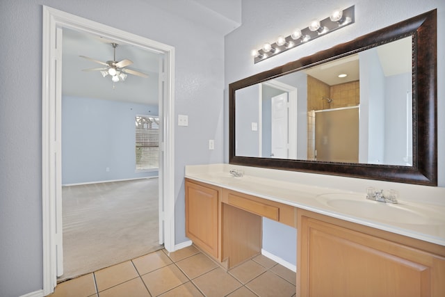 bathroom with a shower with door, vanity, ceiling fan, and tile patterned floors