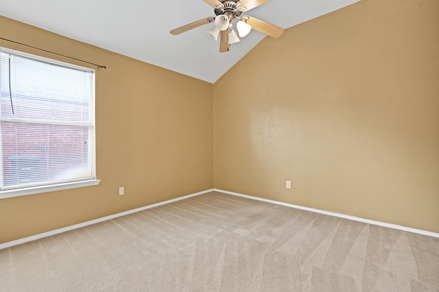 carpeted spare room with lofted ceiling and ceiling fan