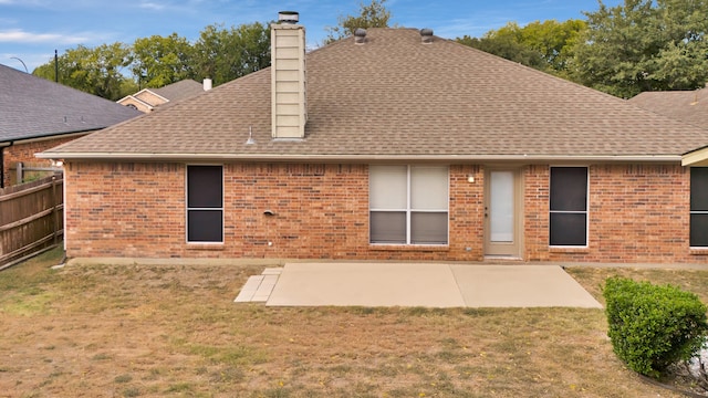 rear view of house featuring a patio and a yard