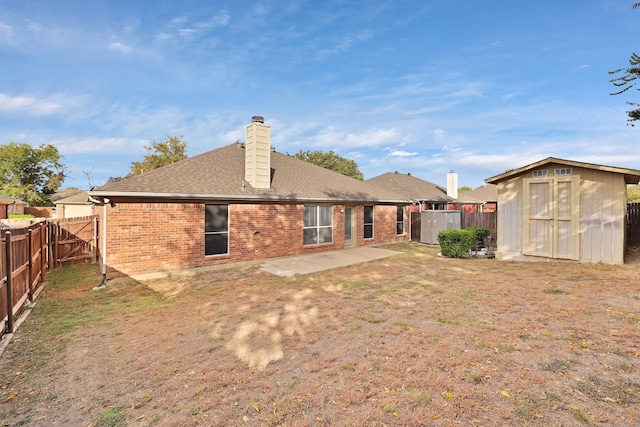 back of house with a patio area and a storage unit