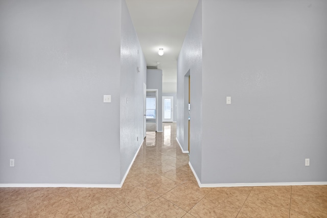 hall featuring light tile patterned flooring