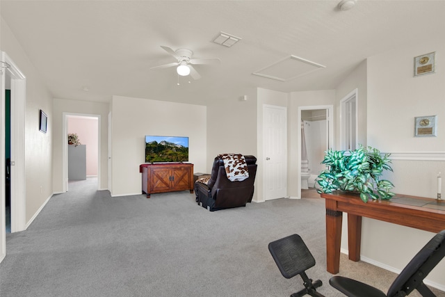 carpeted home office featuring ceiling fan