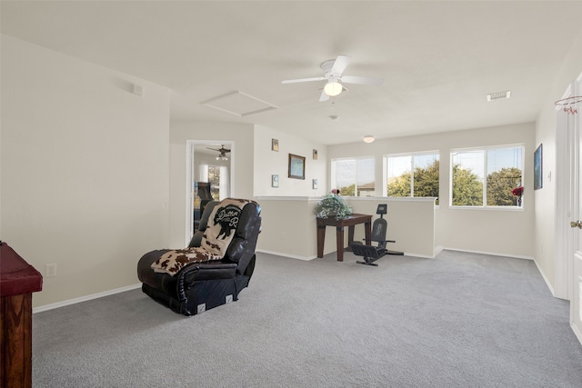 living area featuring light carpet