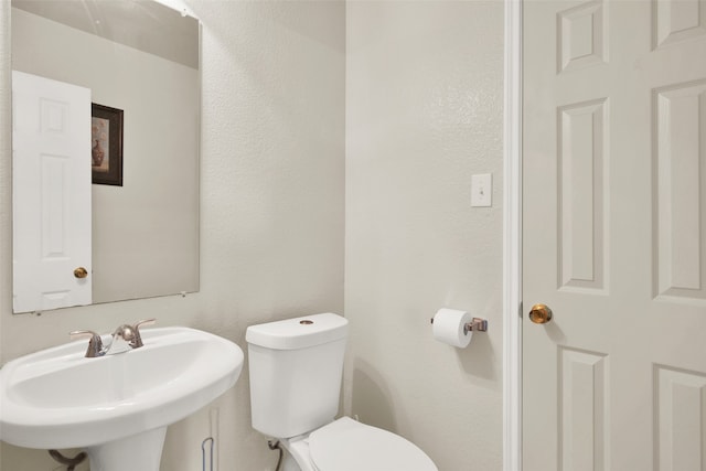 bathroom with toilet and sink