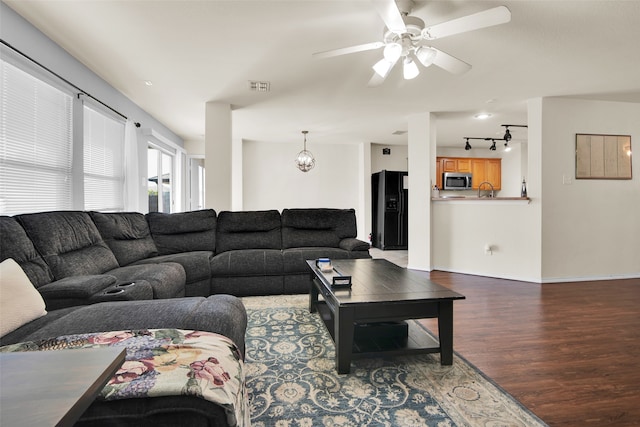 living room with hardwood / wood-style floors, rail lighting, and ceiling fan