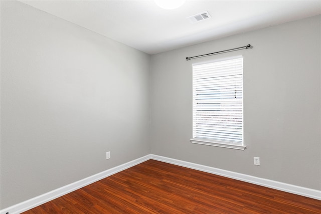 spare room with plenty of natural light and wood-type flooring