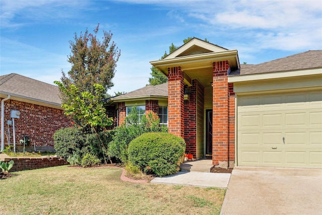 view of front of house with a garage and a front lawn