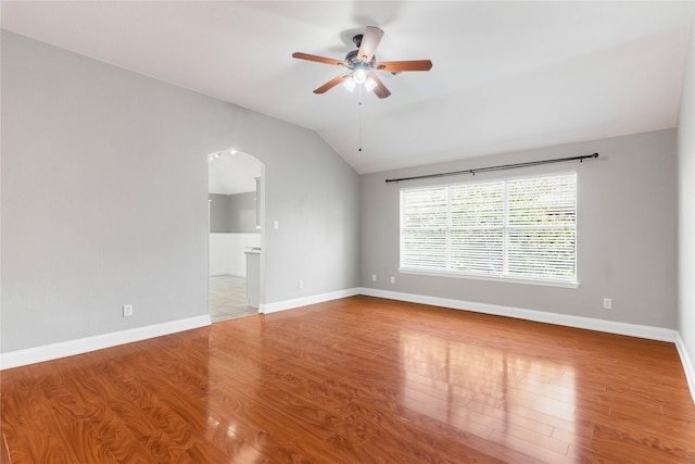 unfurnished living room with ceiling fan, lofted ceiling, and wood-type flooring