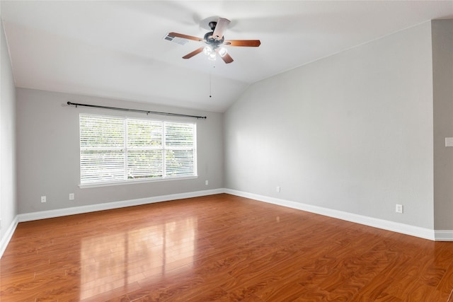 unfurnished room with ceiling fan, hardwood / wood-style floors, and vaulted ceiling