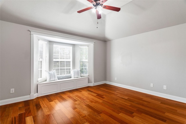 unfurnished room with wood-type flooring, ceiling fan, and lofted ceiling