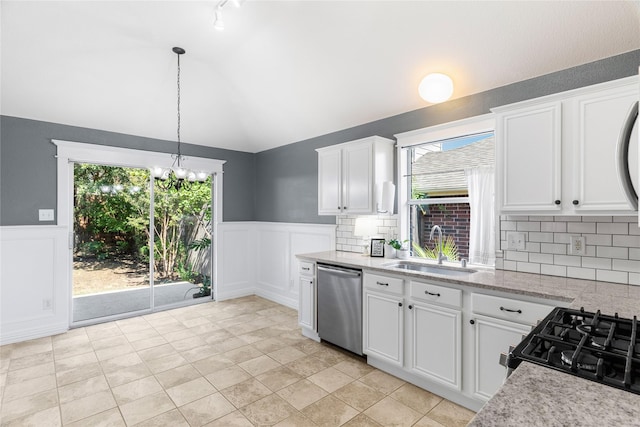 kitchen featuring dishwasher, gas stove, decorative light fixtures, white cabinetry, and sink